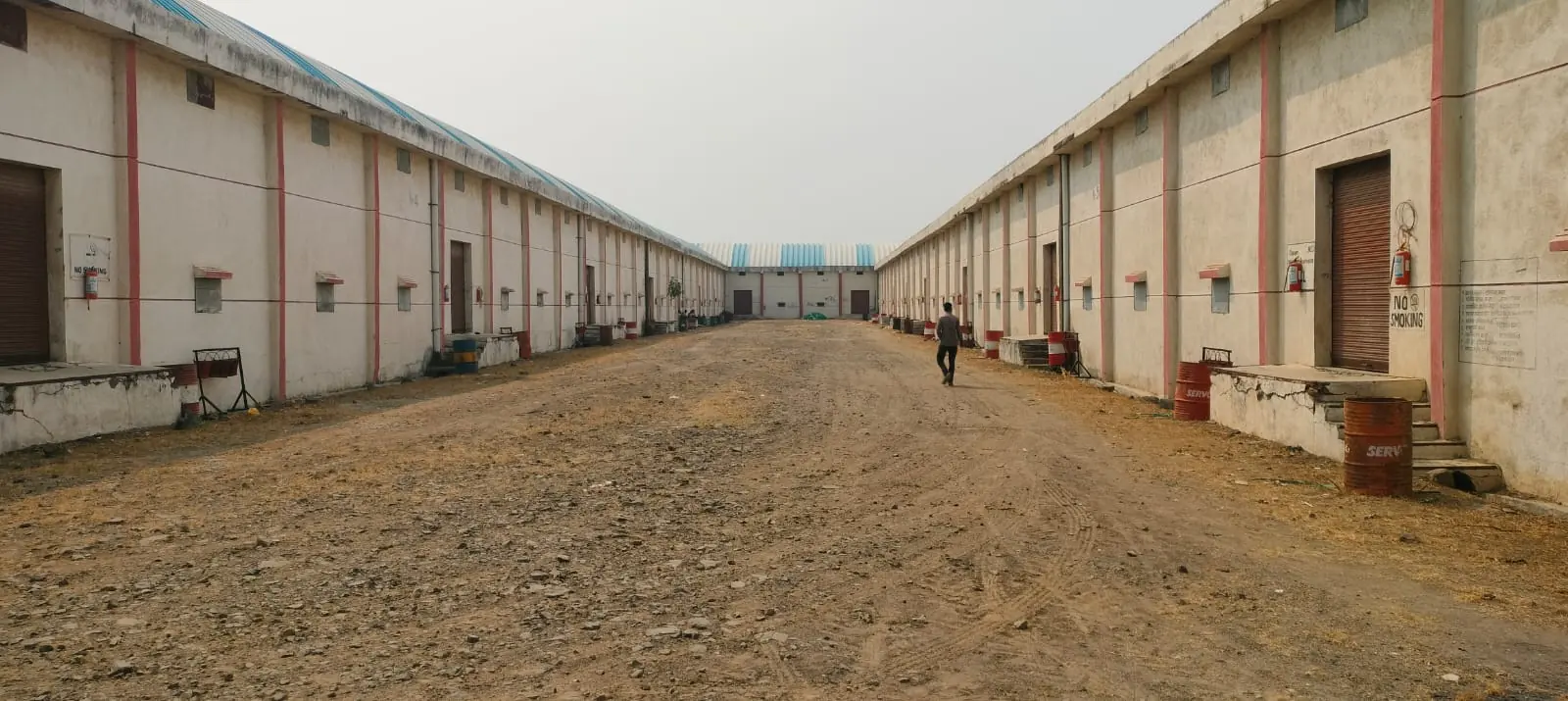 Two rows of A-grade warehouse chambers with a wide concrete-lined yard between them